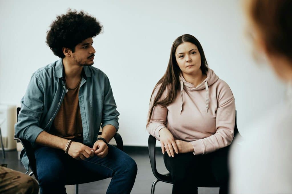 A woman being silent and a man looking at her.