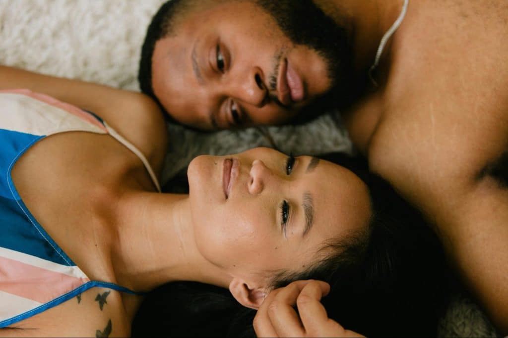 A man and woman laying on the floor