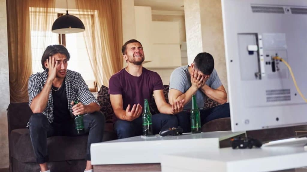 Group of men drinking and becoming emotional