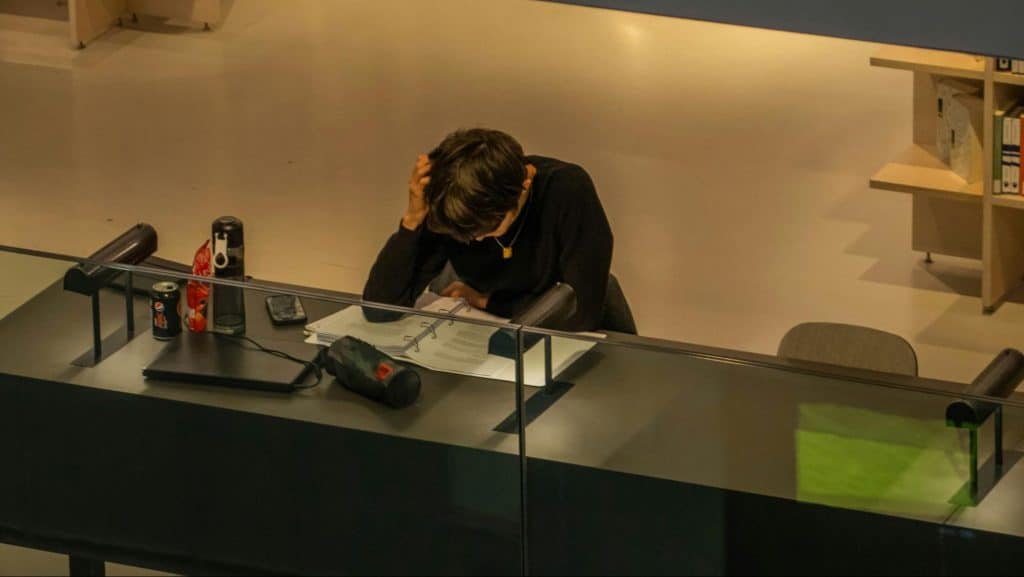 A man sitting alone at his own desk.