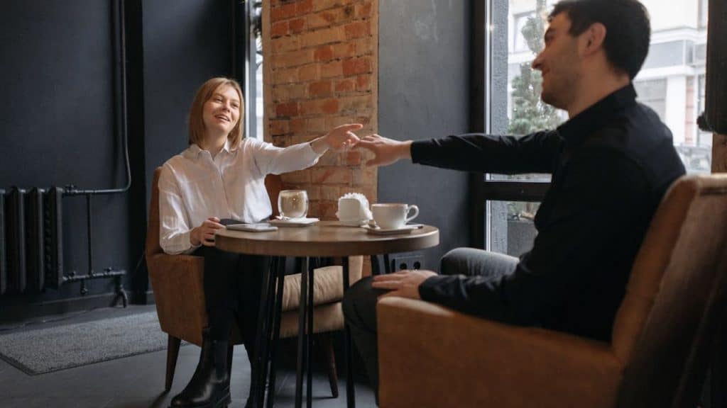 Woman giving a subtle compliment while talking to a man