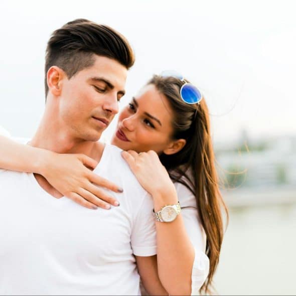 A woman hugging a man.