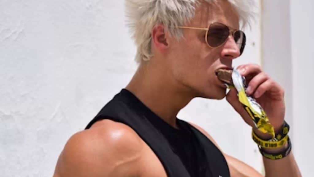 Man eating a store bought protein bar.