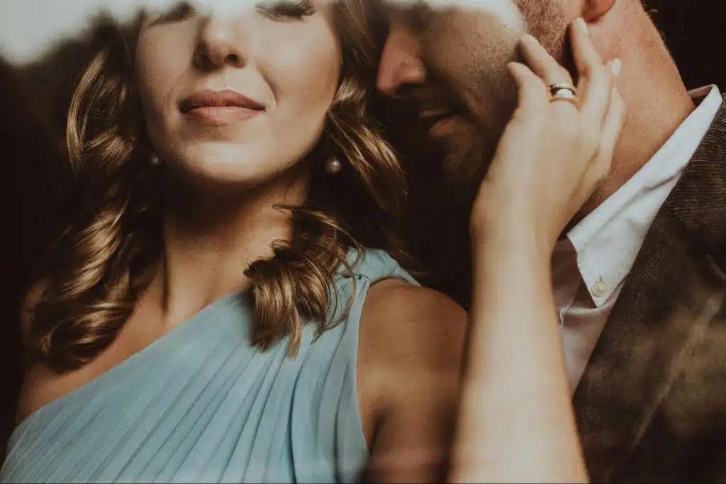 A man whispering something to a woman