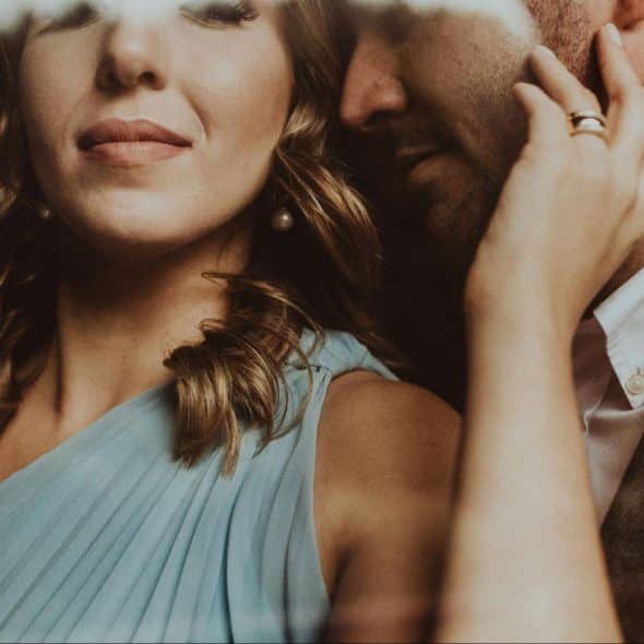 A man whispering something to a woman