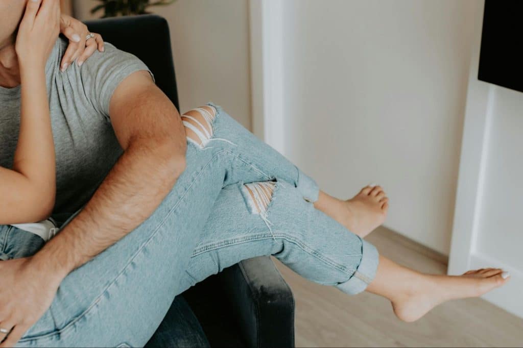 A man and woman sitting on the couch