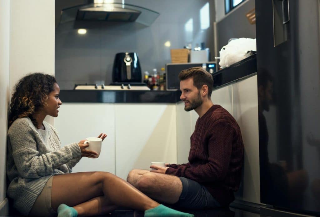 A couple sitting at the floor while talking