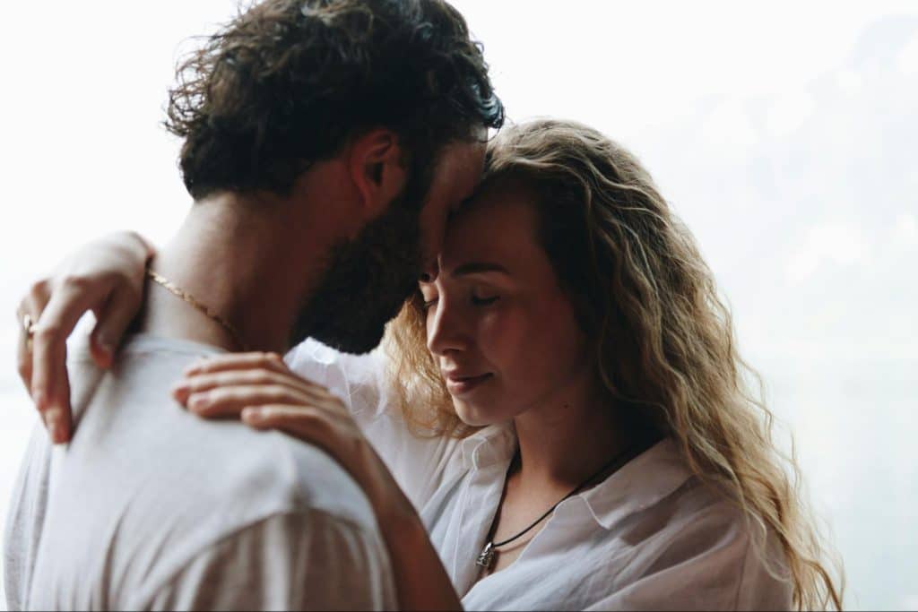 A man and woman being close to each other.