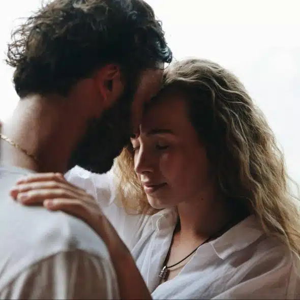 A man and woman being close to each other.