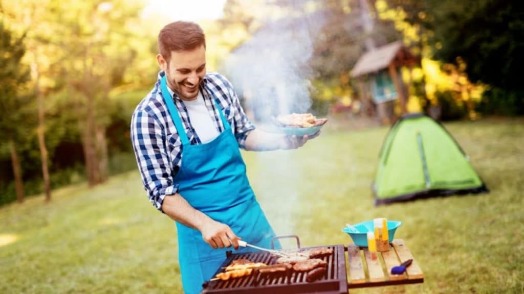 Proud man manning the barbecue like it’s a serious sport