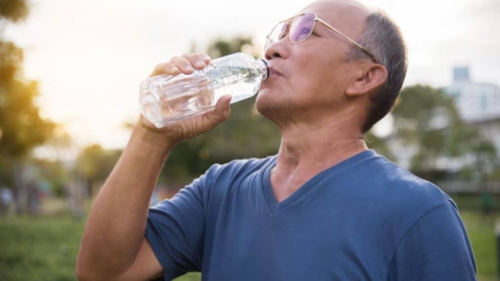 Middle aged man staying hydrated during daily activity
