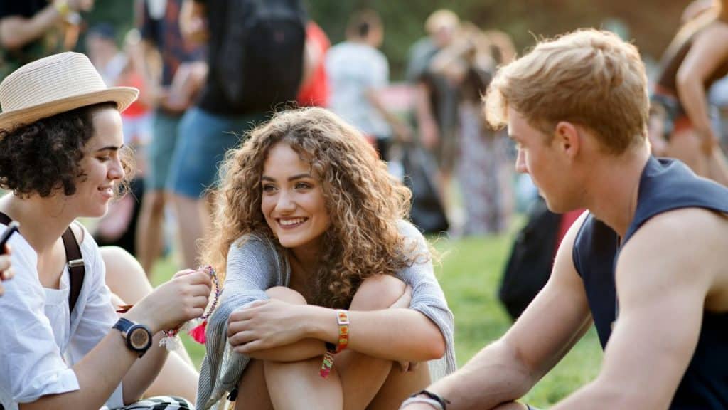 A happy group of young people gathered outdoors on a sunny day.