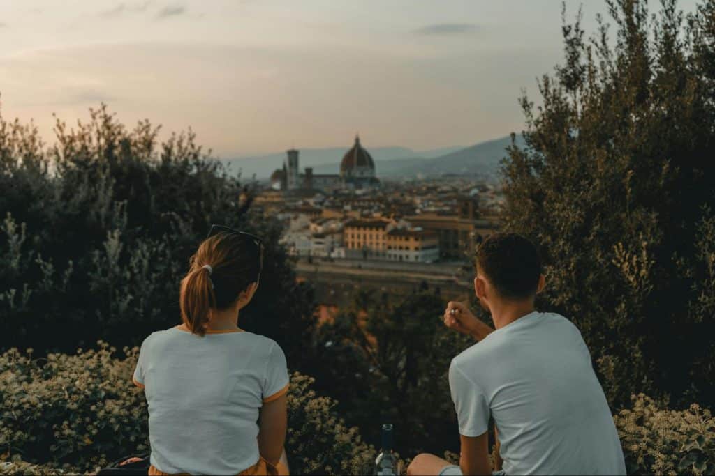 A man and woman talking while looking at the view 