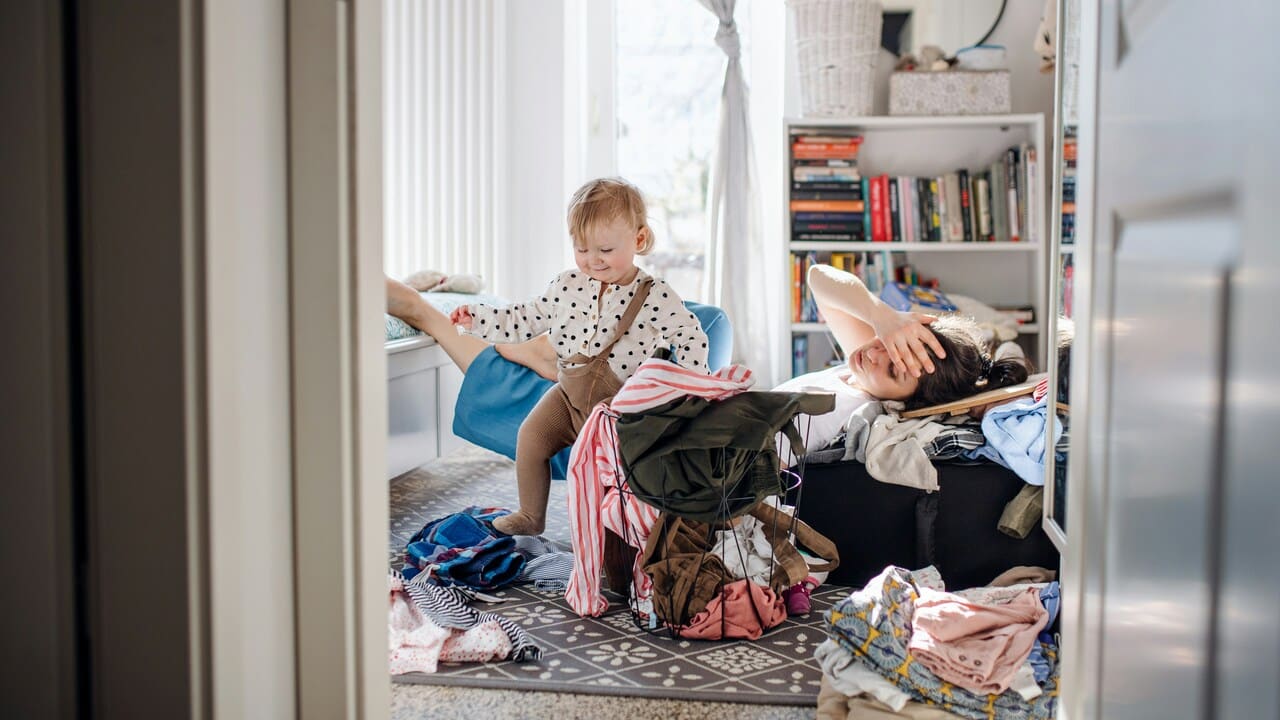 Frustrated mother in a messy room.
