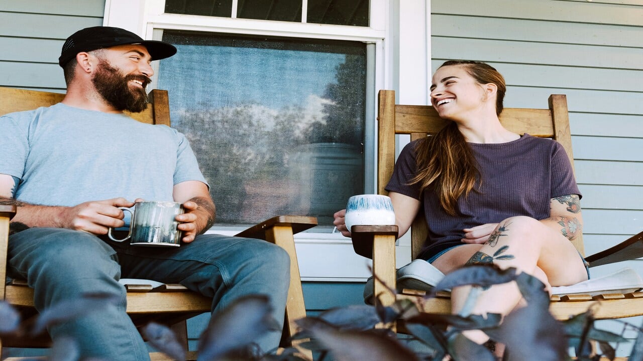 A couple sitting on the porch.