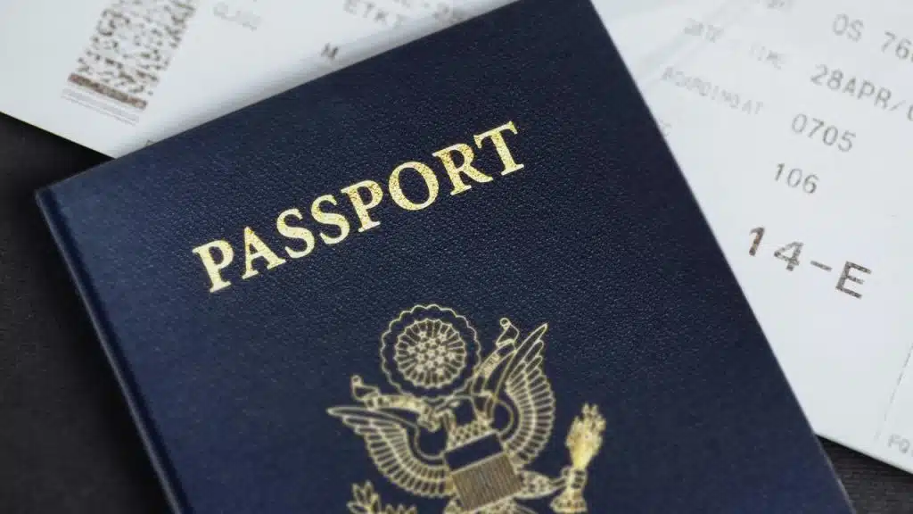 A US passport resting on a boarding pass.