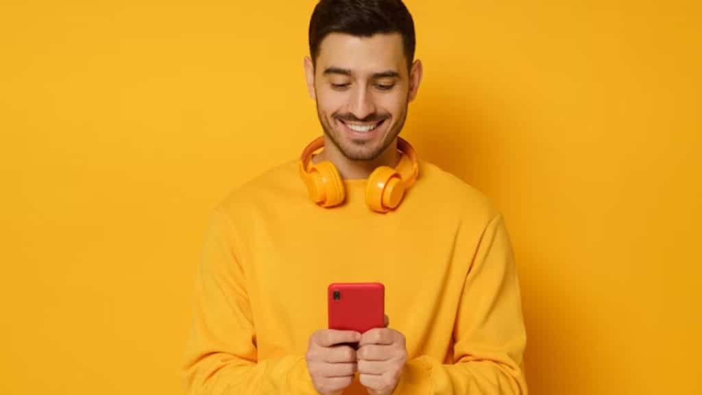 Man sending a voice note with a warm smile.