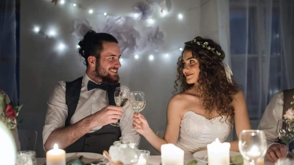 A bride and groom toasting at their reception.