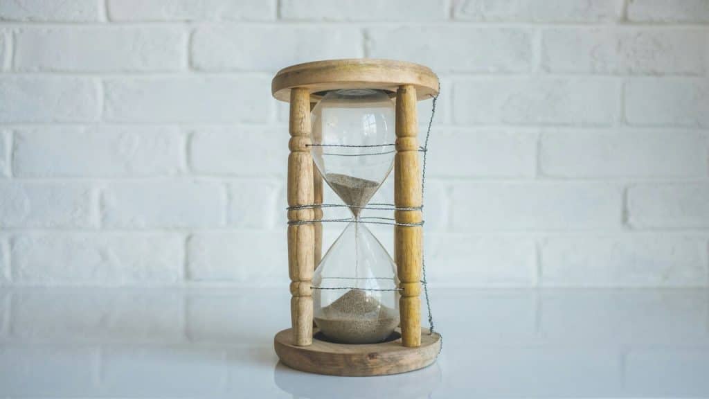 An hourglass on a white table