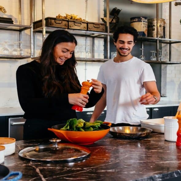 A couple cooking together in the kitchen