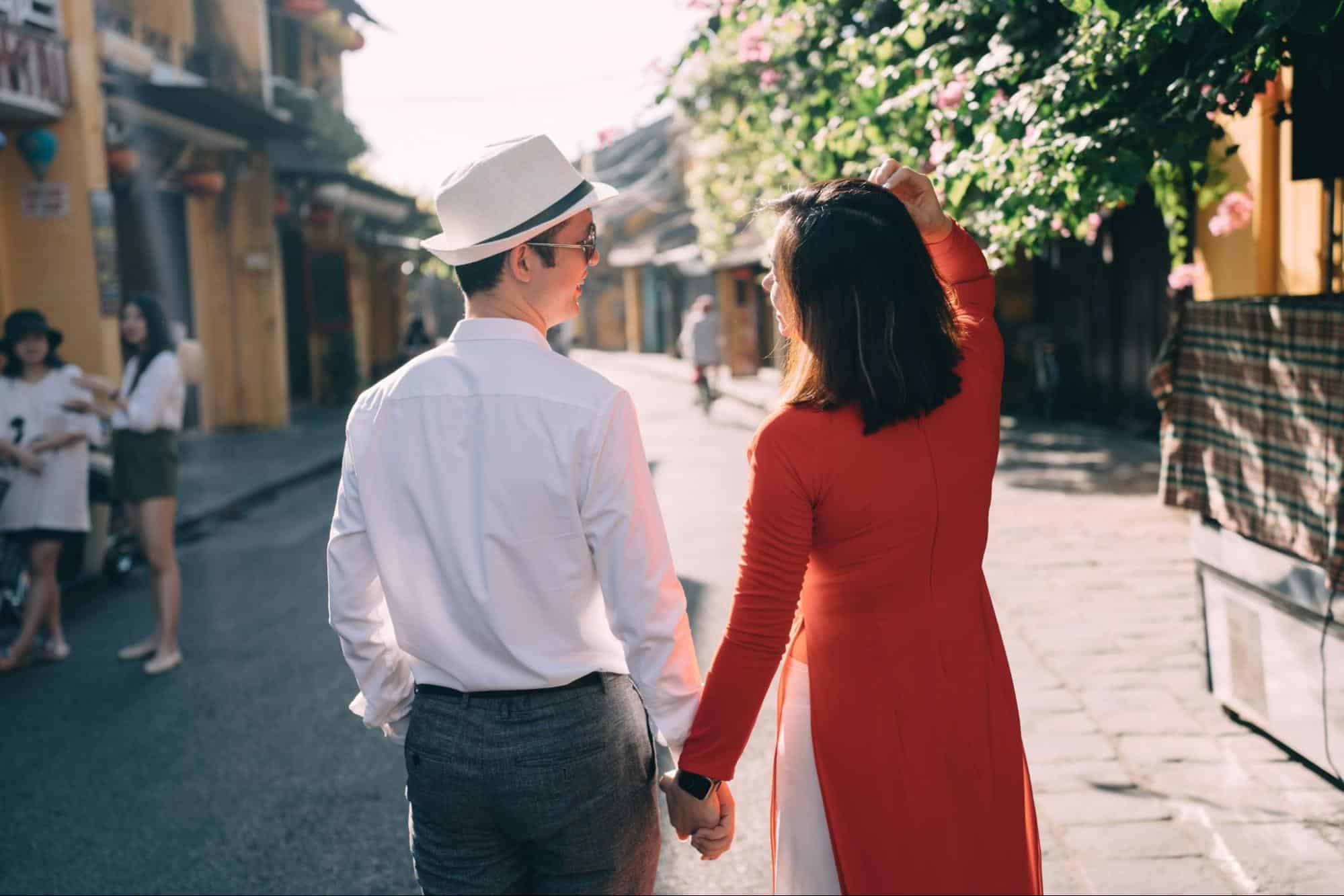A man and woman walking outside.
