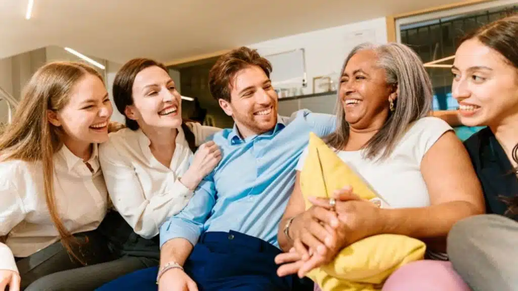 Man engaging with his partner’s friends or family.