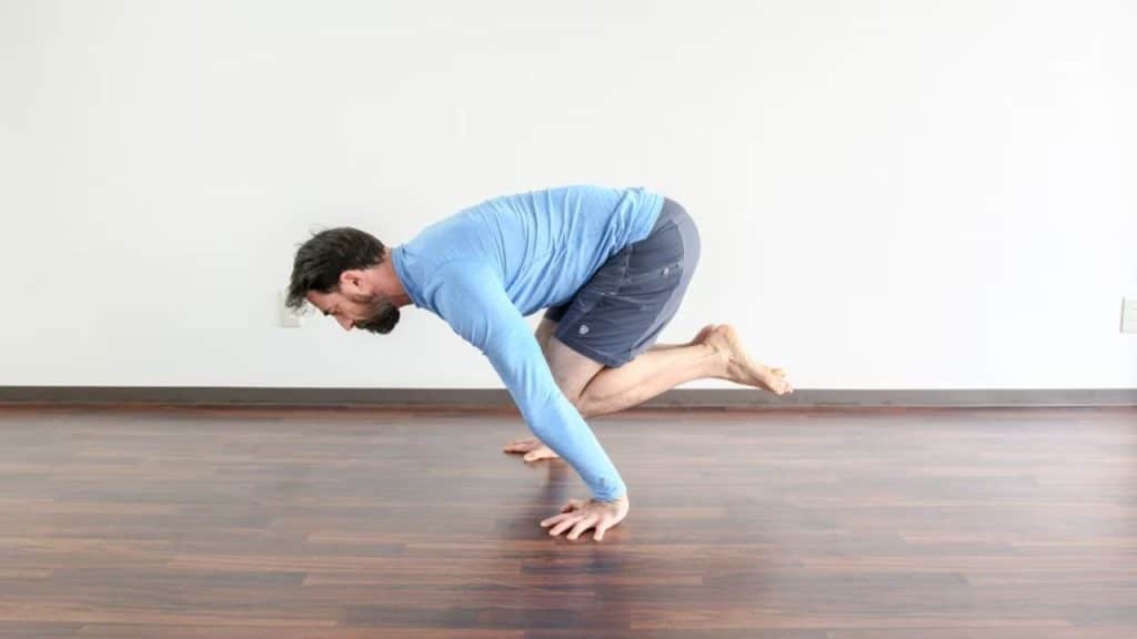 Middle aged man dramatically stretching like he’s prepping for exercise