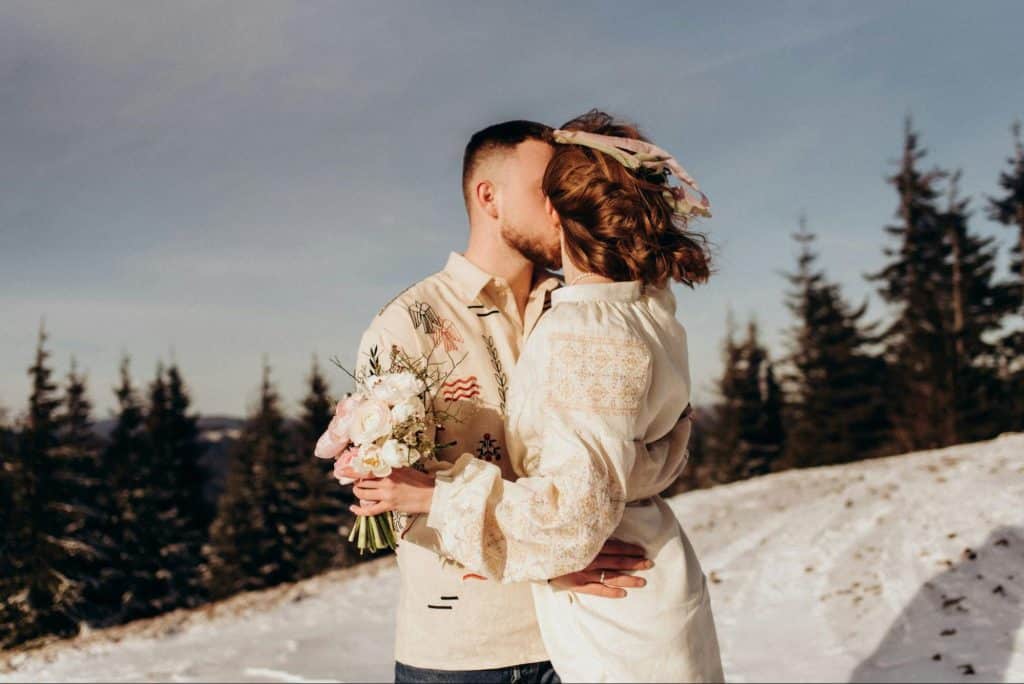 A man kissing a woman’s face