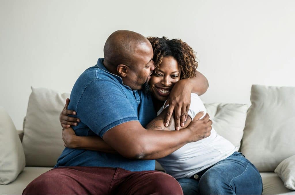 A man hugging tight his partner