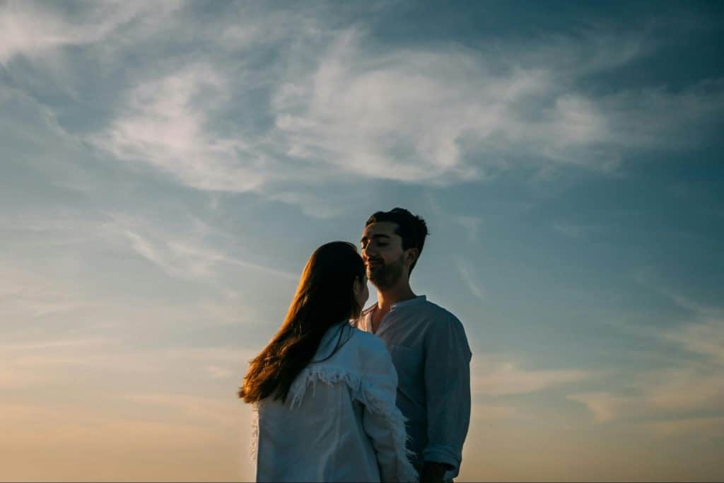 A man and woman facing each other 