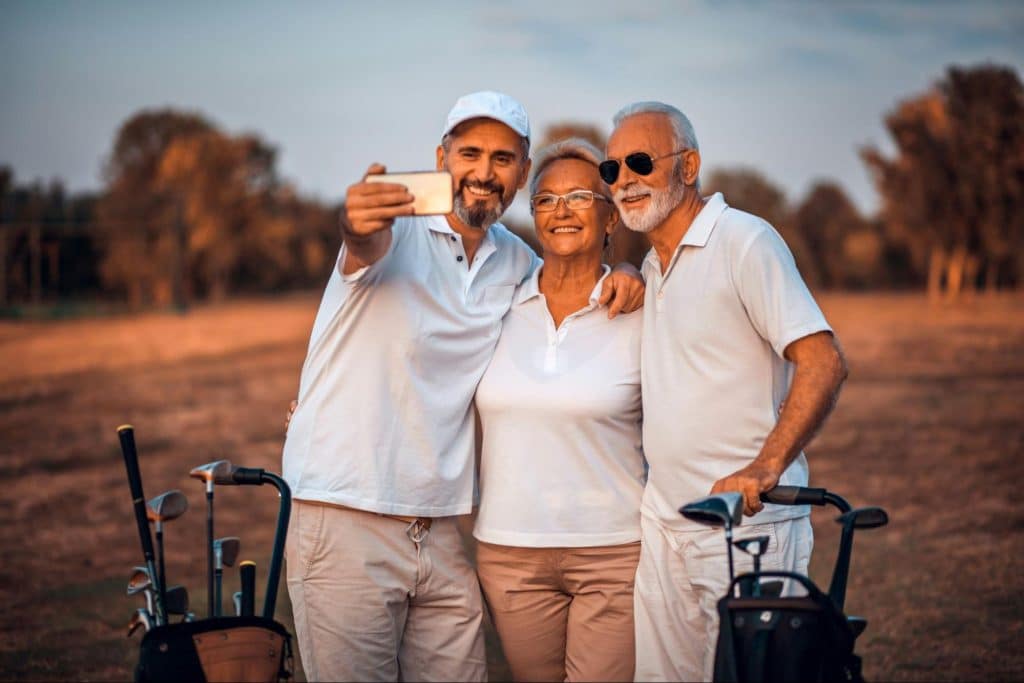 A man having a selfie with his mom and dad.