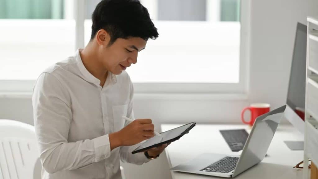 A man reviewing a budget or planning a future goal on a tablet