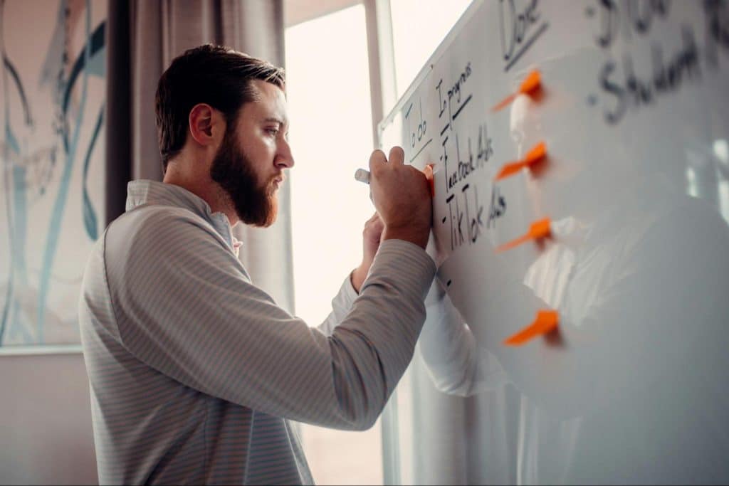 A man taking notes at the board