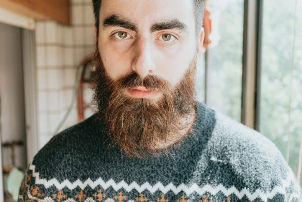 A man with a maintained beard.