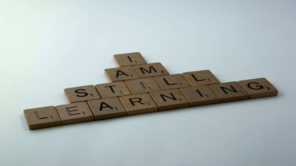 Wooden blocks spelling out “I am still learning”
