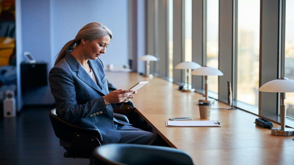 A businesswoman using her device at work