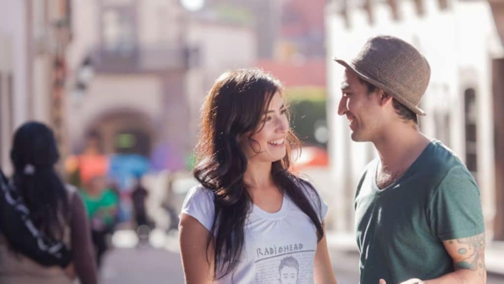 Man smiling genuinely at someone to signal friendly interest