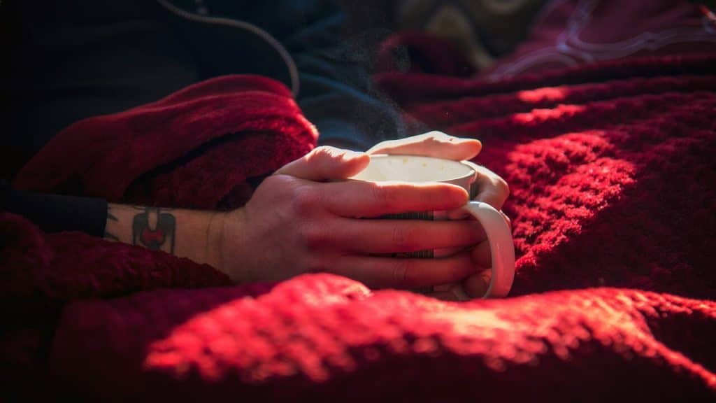 A person having coffee in bed