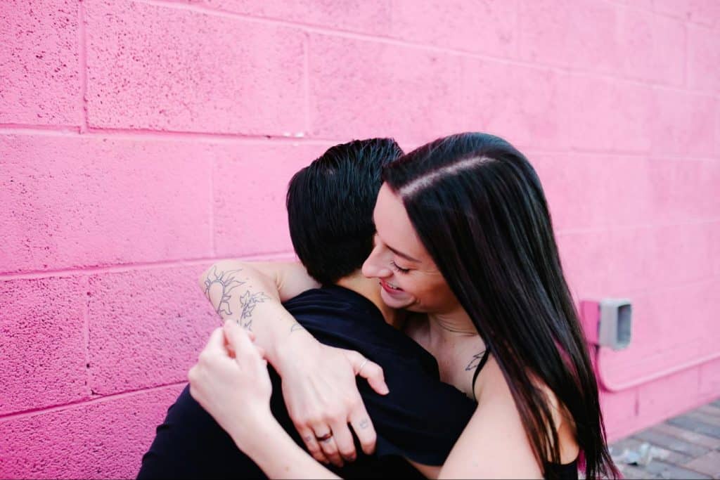 A woman hugging a man
