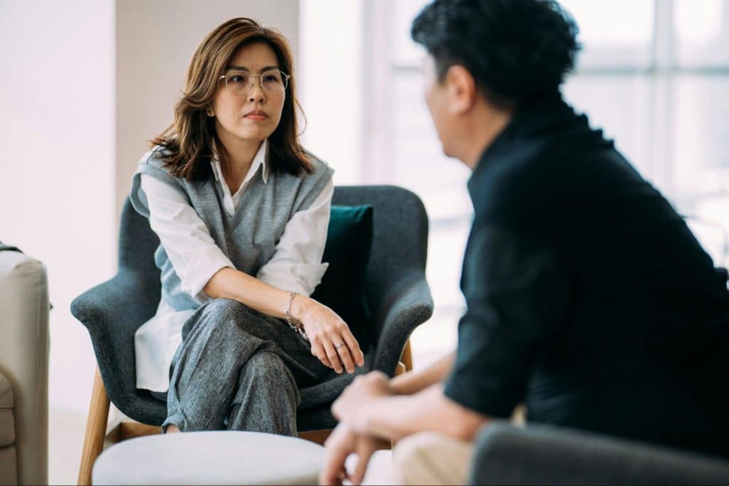 A man apologizing to a woman 