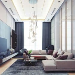 A luxurious modern living room with a large sectional sofa, TV, and unique chandelier.