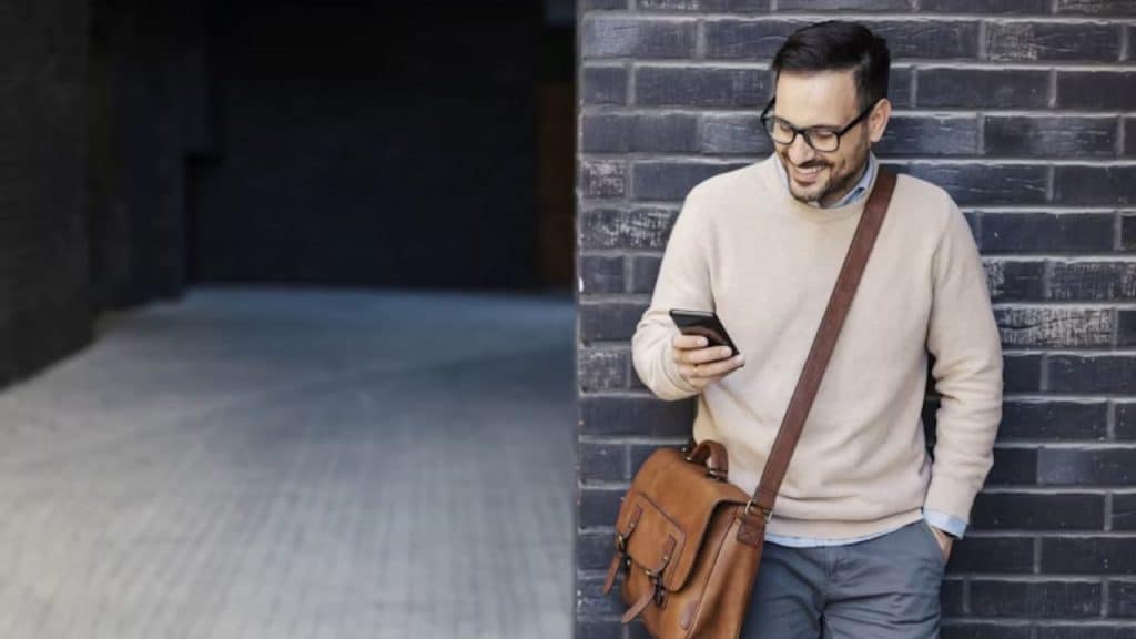 Man smiling as he sends a casual check in message