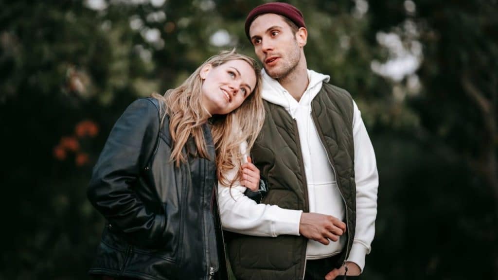 Woman and man mirroring each other’s stance while talking and walking