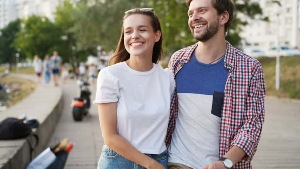 A couple enjoying a walk, laughing and relaxed, phones out of sight
