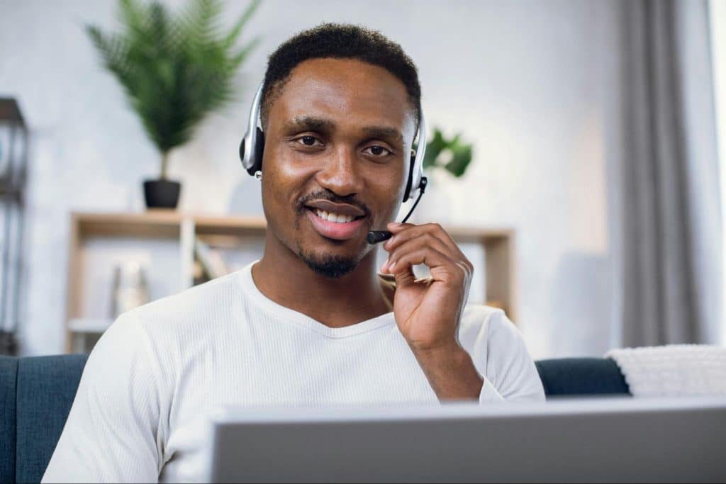A man using a laptop smiling.