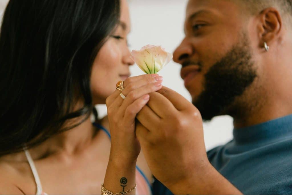 A man giving a flower to a woman