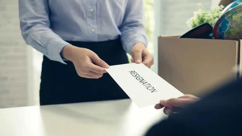 An employee handing a resignation letter