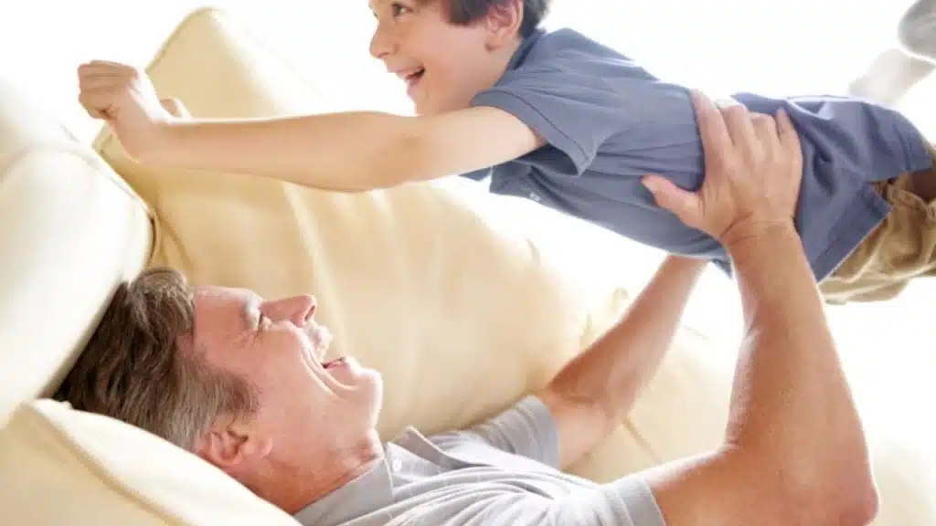  Dad working out at home while his children join in.
