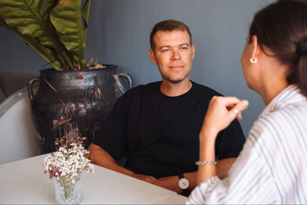 A man listening to a woman.