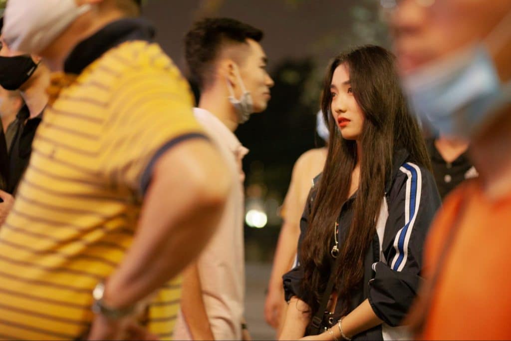 A woman getting upset seeing her boyfriend supporting others.